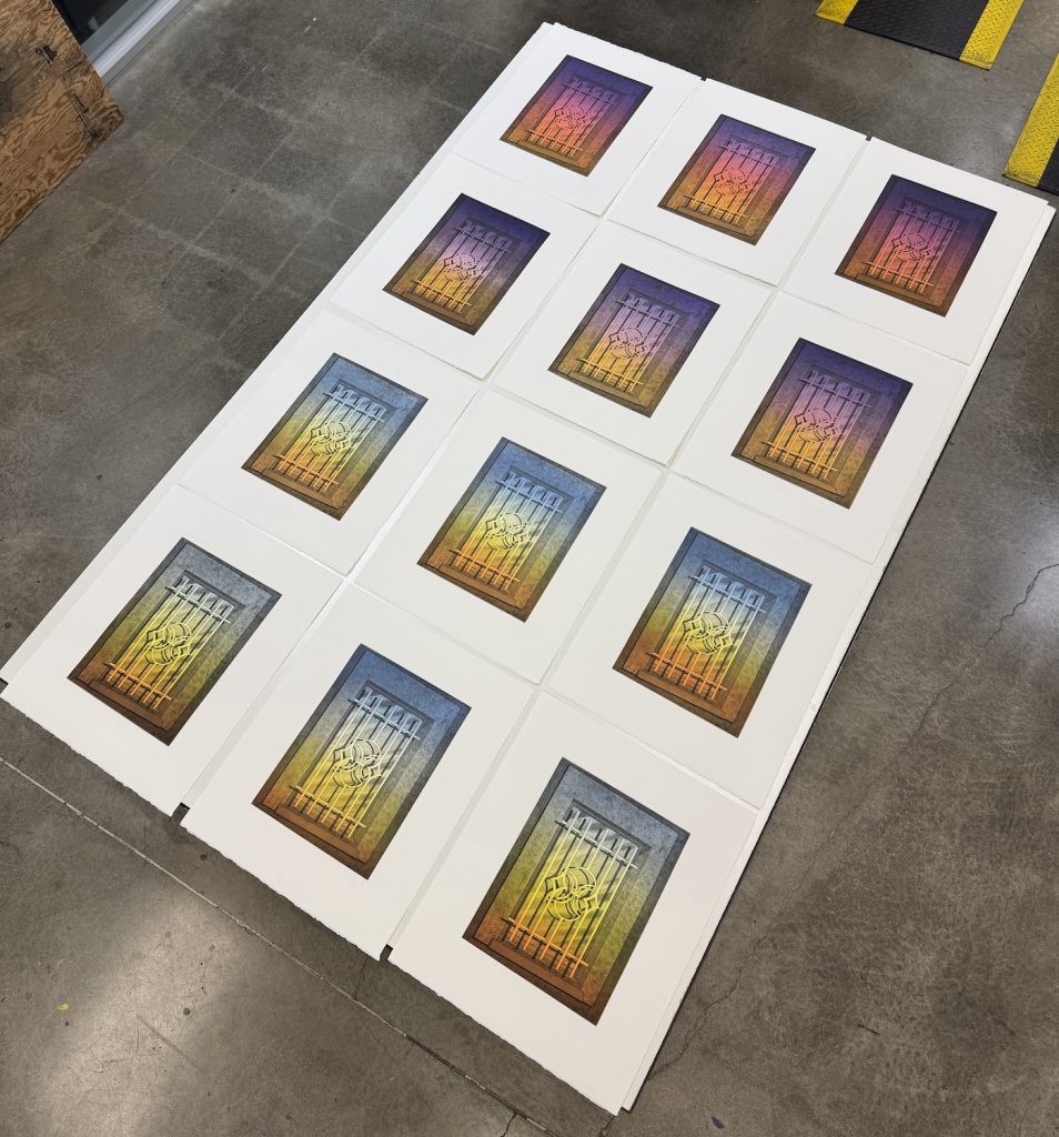 A collection of twelve art prints laid out on a flat surface, each featuring a stylized image of a prison cell with vibrant gradient colors transitioning from purple to orange and yellow.