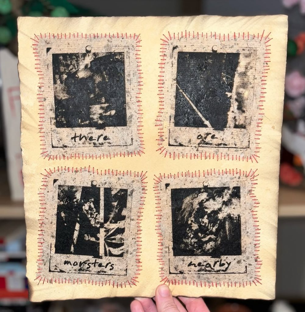 A handmade art piece featuring four black and white images on distressed paper with red stitching. The images contain the words 'there', 'are', 'monsters', and 'nearby'.