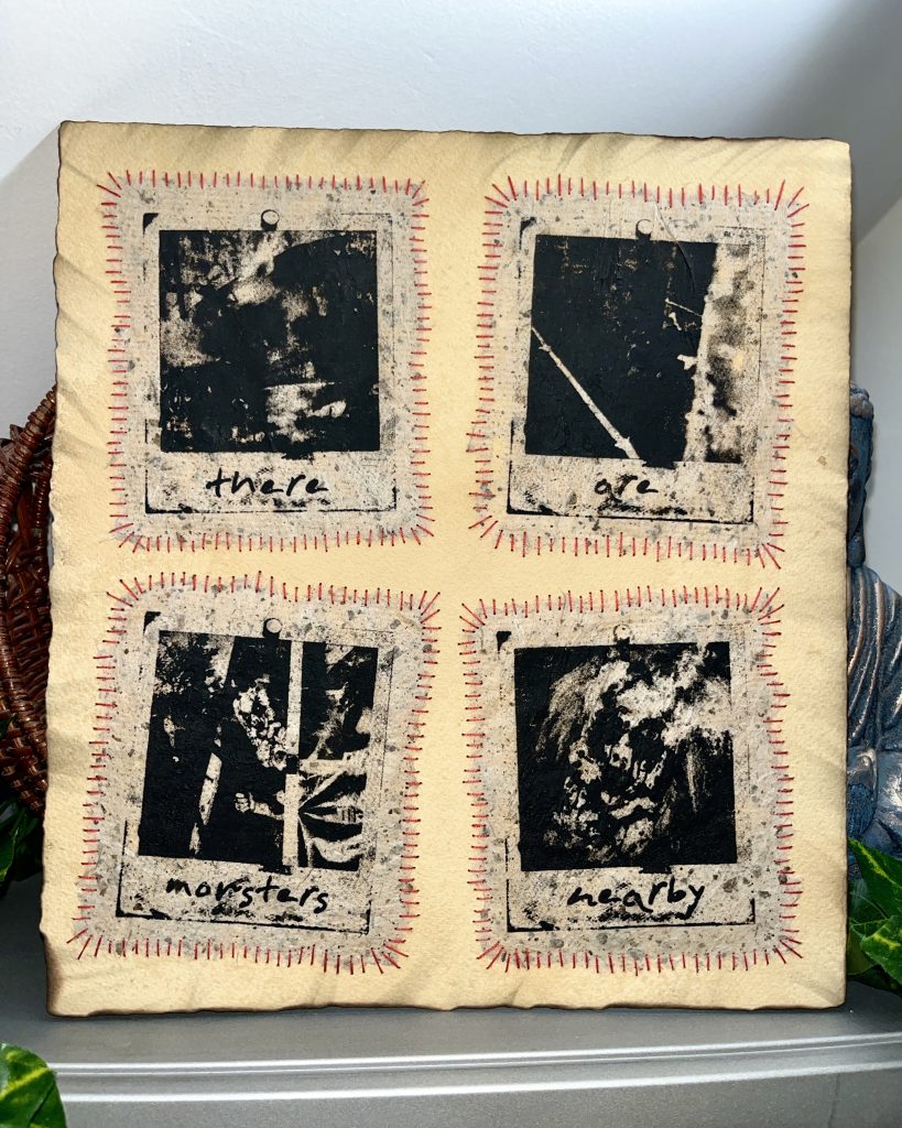 Art piece featuring four black and white photographs on textured paper, with stitched borders, displaying the words 'there', 'are', 'monsters', and 'nearby'.