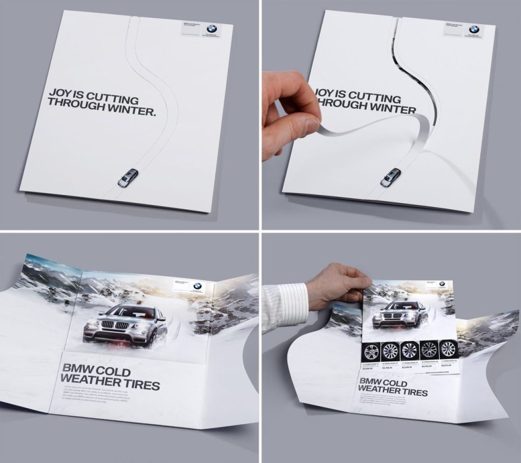 A promotional brochure featuring a BMW vehicle on a snowy road with the text 'JOY IS CUTTING THROUGH WINTER.'