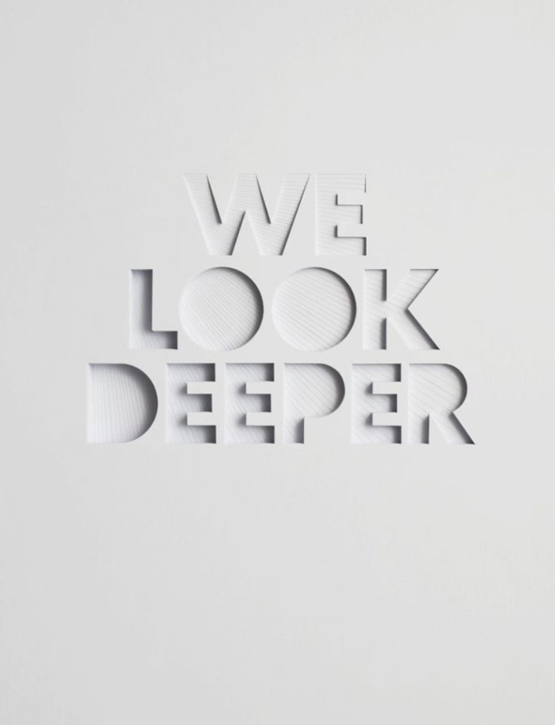 White textured background with the words 'WE LOOK DEEPER' intricately cut out, showcasing depth and dimension.